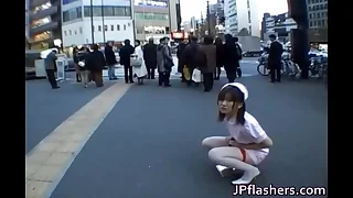 Naughty Asian girl is pissing close by public